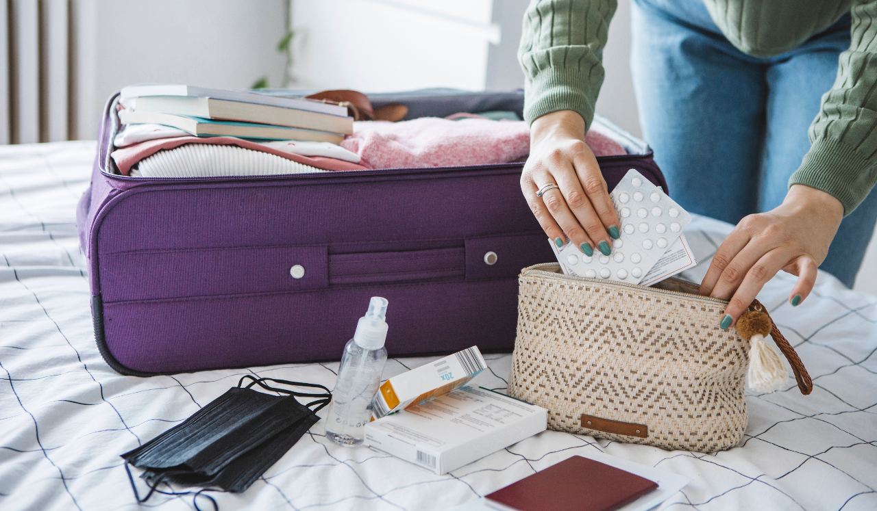Person packing suitcase for trip