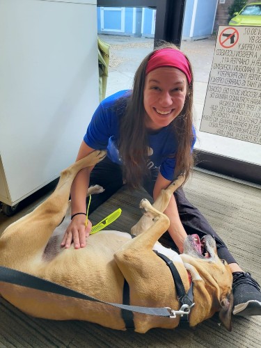 TIRR Memorial Hermann patient, Alese Zeman, plays with her dog post-recovery.